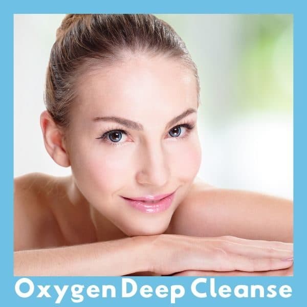 Woman smiling and showing her clear skin after an oxygen deep cleanse.