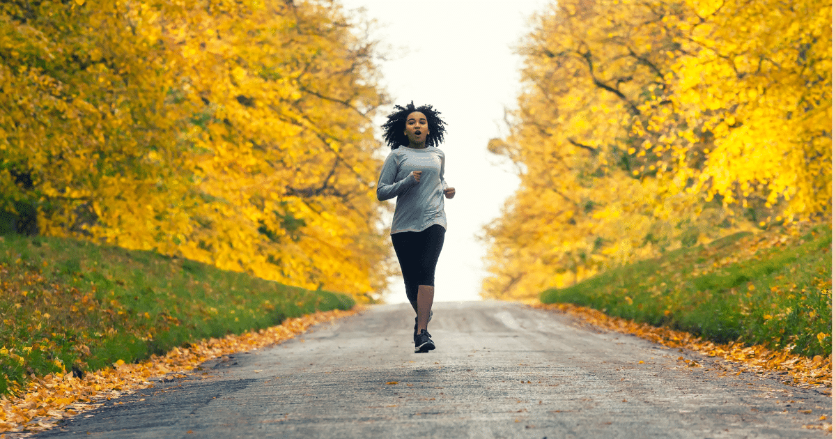 A curly-haired black woman running