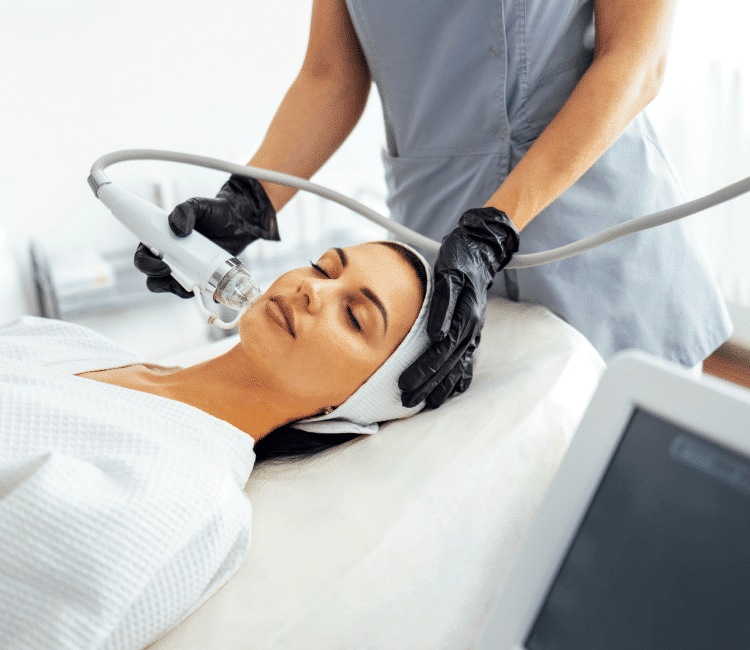 A woman lying while receiving a Lutronic Genius® RF Microneedling.