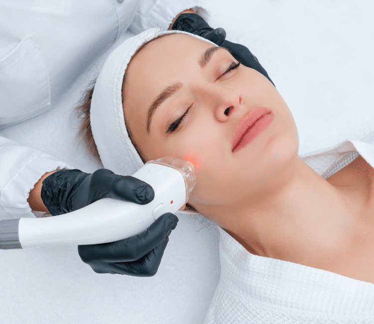 A woman patient lying while receiving Lutronic LaseMD ULTRA™ Laser Resurfacing​, a service offered at Docere Medspa.